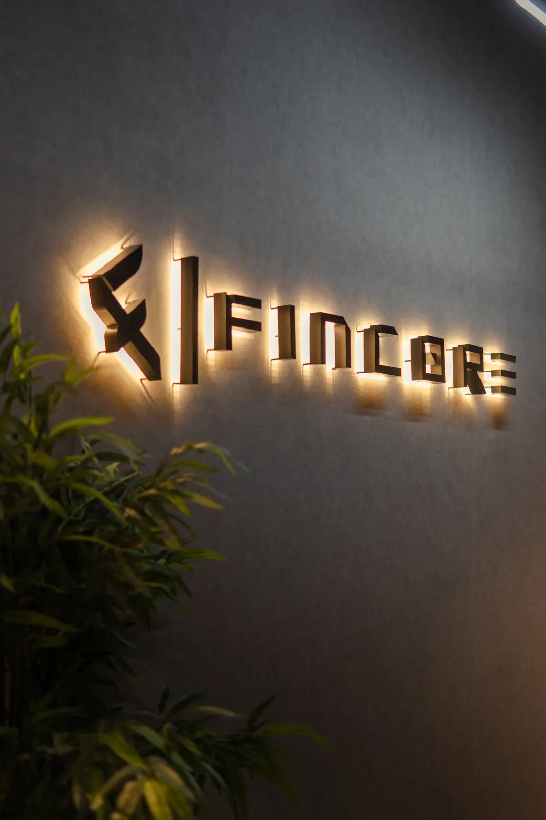 The lit Fincore sign on the office wall